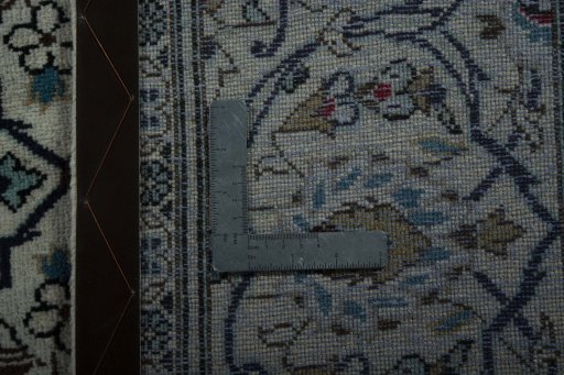 Backside of handmade 2000s Kashan rug showing knot structure and weave density