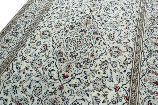 Backside of handmade 2000s Kashan rug showing knot structure and weave density