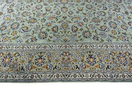 Corner detail of 2000s Kashan rug showing border pattern and Wool pile