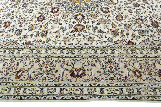 Corner detail of 2000s Kashan rug showing border pattern and Cork pile