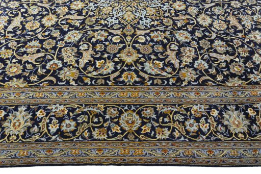 Corner detail of 2000s Kashan rug showing border pattern and Wool pile