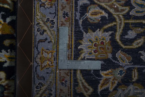 Backside of handmade 2000s Kashan rug showing knot structure and weave density