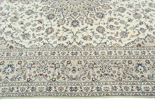 Corner detail of 2000s Kashan rug showing border pattern and Cork pile