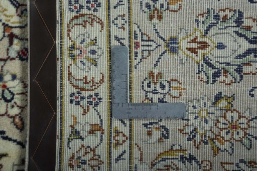 Backside of handmade 2000s Kashan rug showing knot structure and weave density