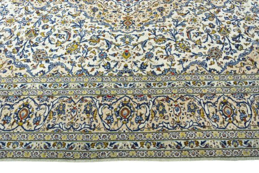 Corner detail of 2000s Kashan rug showing border pattern and Wool pile