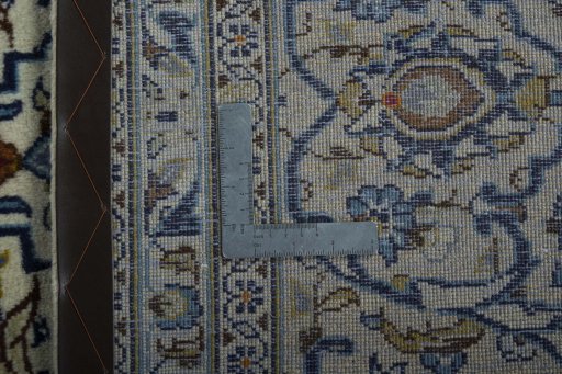Backside of handmade 2000s Kashan rug showing knot structure and weave density