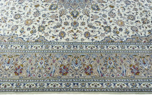 Corner detail of 2000s Kashan rug showing border pattern and Wool pile