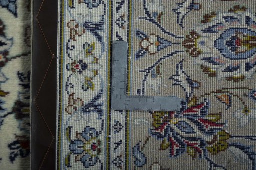 Backside of handmade 2000s Kashan rug showing knot structure and weave density