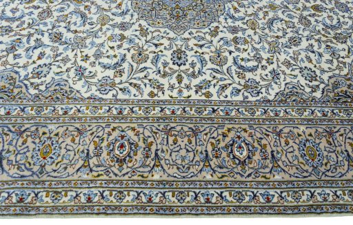 Corner detail of 2000s Kashan rug showing border pattern and Wool pile