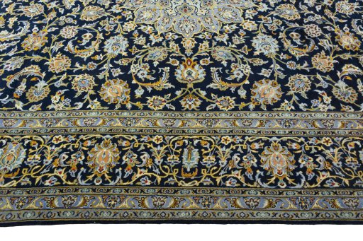 Corner detail of 2000s Kashan rug showing border pattern and Wool pile