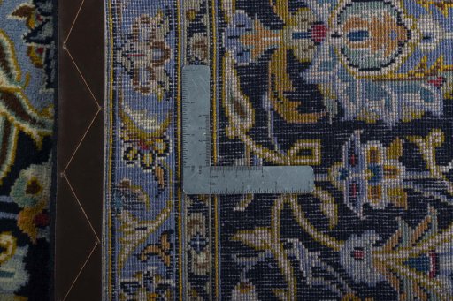 Backside of handmade 2000s Kashan rug showing knot structure and weave density