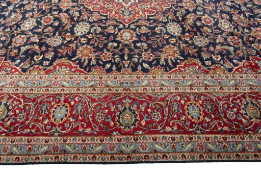 Corner detail of 2000s Kashan rug showing border pattern and Wool pile