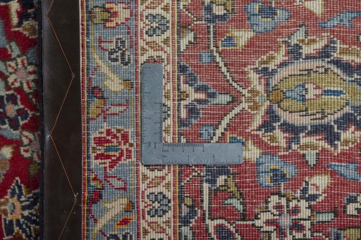 Backside of handmade 2000s Kashan rug showing knot structure and weave density