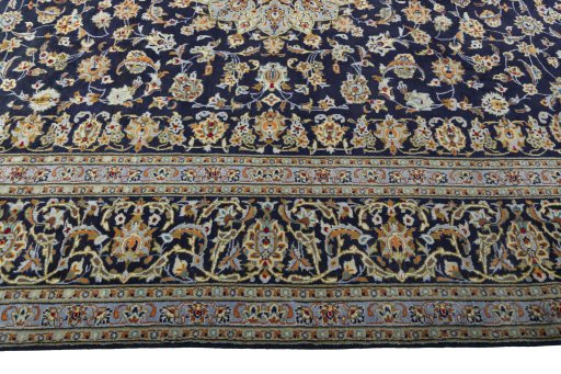 Corner detail of 2000s Kashan rug showing border pattern and Wool pile