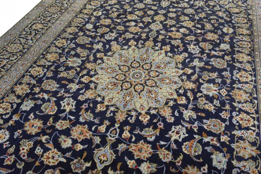 Backside of handmade 2000s Kashan rug showing knot structure and weave density