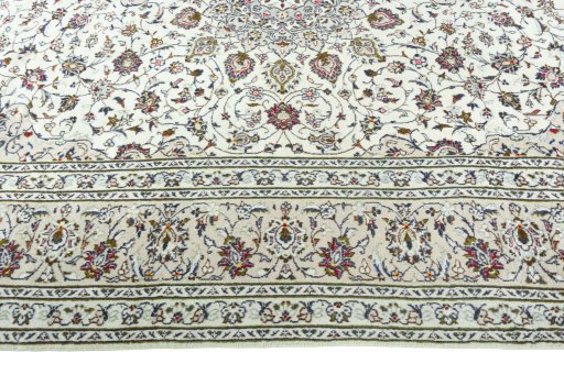 Corner detail of 2000s Kashan rug showing border pattern and Wool pile