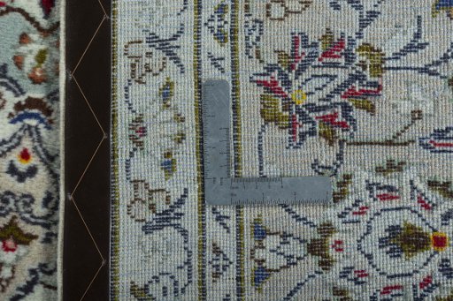 Backside of handmade 2000s Kashan rug showing knot structure and weave density