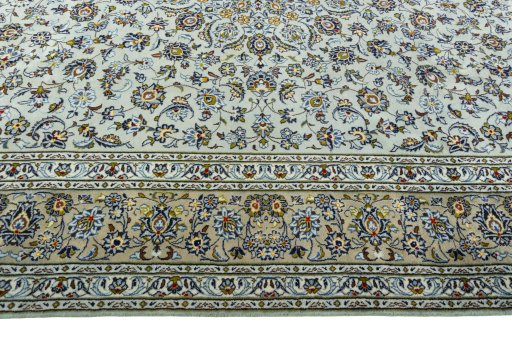 Corner detail of 2000s Kashan rug showing border pattern and Wool pile