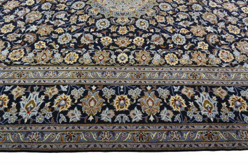 Corner detail of 2000s Kashan rug showing border pattern and Wool pile