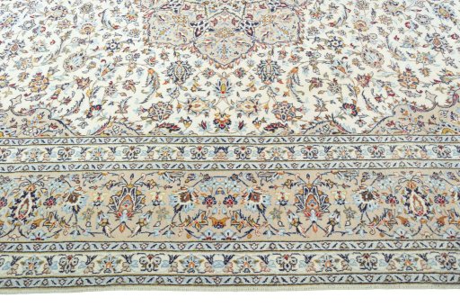 Corner detail of 2000s Kashan rug showing border pattern and Wool pile