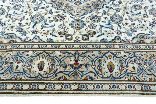 Corner detail of 2000s Kashan rug showing border pattern and Wool pile