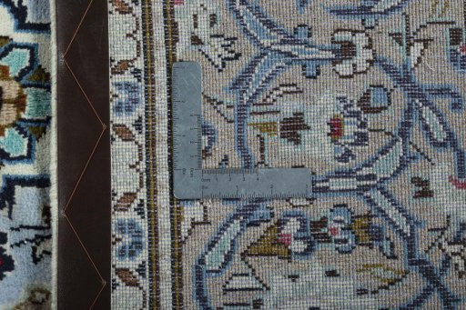 Backside of handmade 2000s Kashan rug showing knot structure and weave density