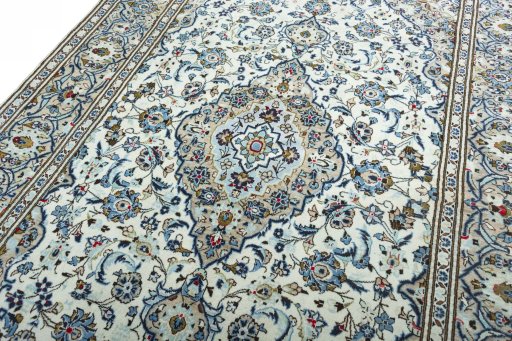 Backside of handmade 2000s Kashan rug showing knot structure and weave density
