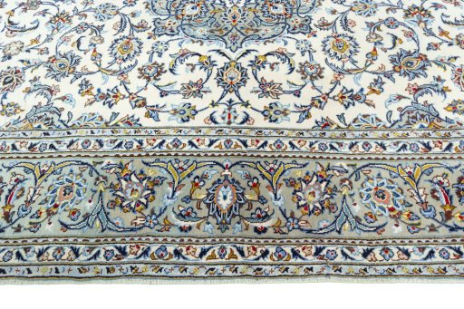 Corner detail of 2000s Kashan rug showing border pattern and Wool pile