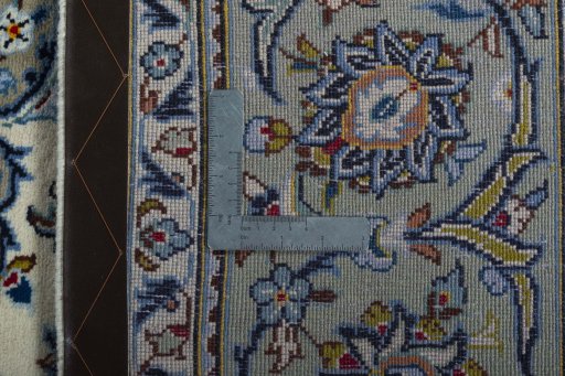 Backside of handmade 2000s Kashan rug showing knot structure and weave density
