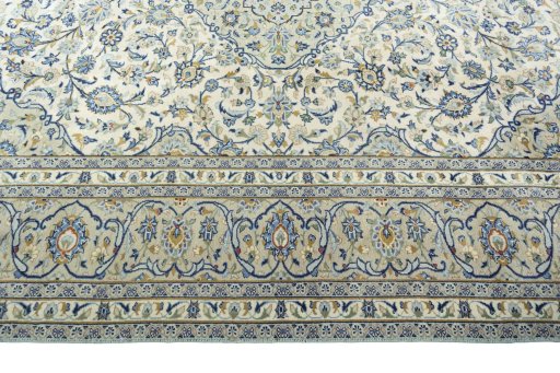 Corner detail of 2000s Kashan rug showing border pattern and Wool pile
