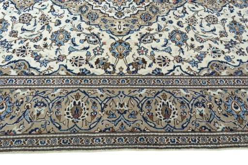 Corner detail of 2000s Kashan rug showing border pattern and Wool pile