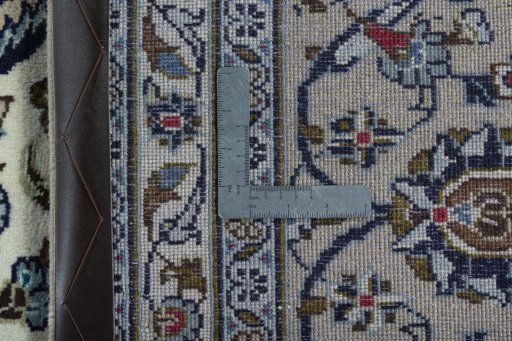 Backside of handmade 2000s Kashan rug showing knot structure and weave density