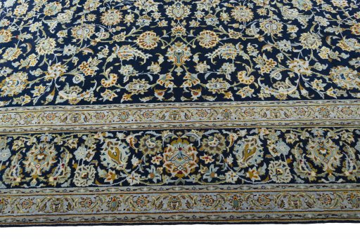 Corner detail of 2000s Kashan rug showing border pattern and Wool pile