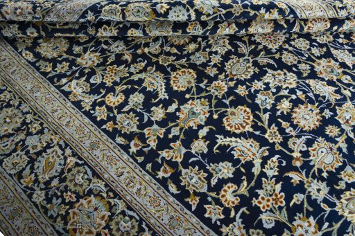 Close-up detail of 2000s Kashan rug from Iran / Persia showing Wool weave