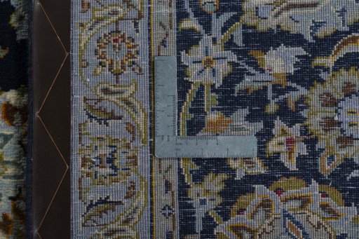 Backside of handmade 2000s Kashan rug showing knot structure and weave density