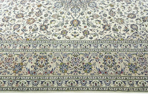 Corner detail of 2000s Kashan rug showing border pattern and Wool pile