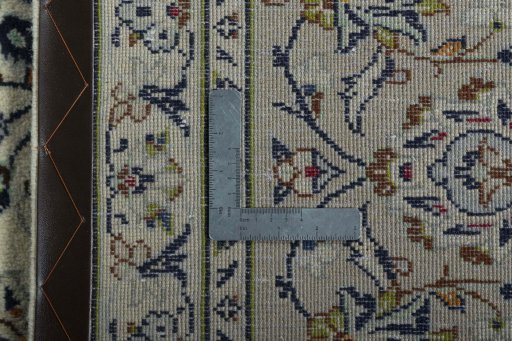 Backside of handmade 2000s Kashan rug showing knot structure and weave density