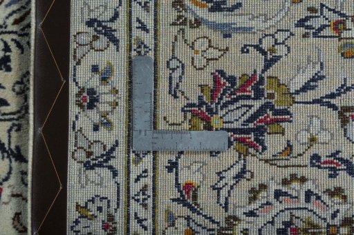 Backside of handmade 2000s Kashan rug showing knot structure and weave density