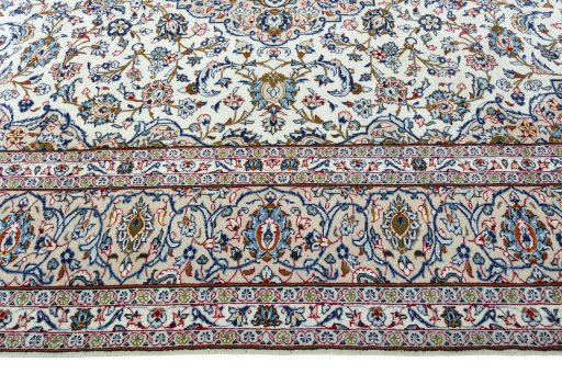 Corner detail of 2000s Kashan rug showing border pattern and Wool pile