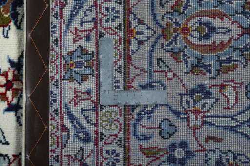 Backside of handmade 2000s Kashan rug showing knot structure and weave density