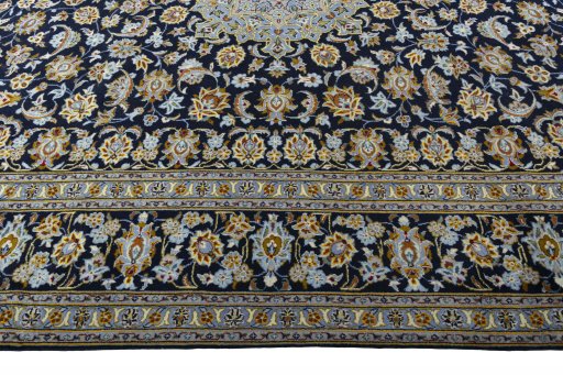 Corner detail of 2000s Kashan rug showing border pattern and Wool pile