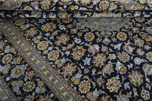 Close-up detail of 2000s Kashan rug from Iran / Persia showing Wool weave