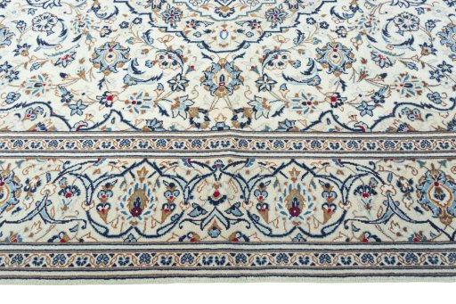 Corner detail of 2000s Kashan rug showing border pattern and Wool pile