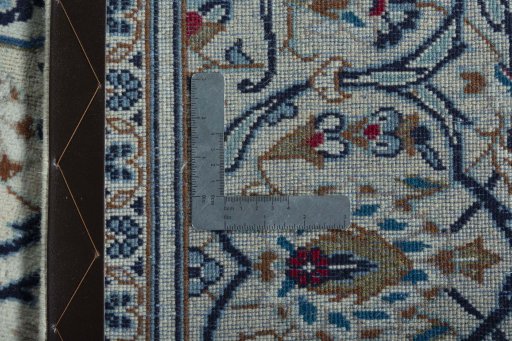Backside of handmade 2000s Kashan rug showing knot structure and weave density