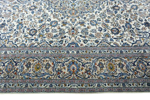 Corner detail of 2000s Kashan rug showing border pattern and Wool pile