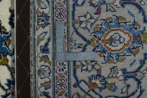 Backside of handmade 2000s Kashan rug showing knot structure and weave density