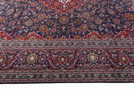 Corner detail of 2000s Kashan rug showing border pattern and Wool pile