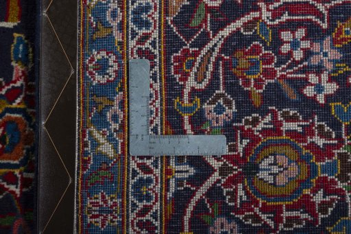 Backside of handmade 2000s Kashan rug showing knot structure and weave density
