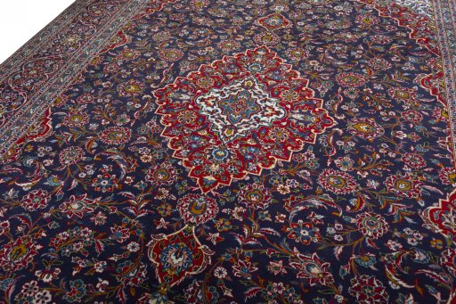 Backside of handmade 2000s Kashan rug showing knot structure and weave density