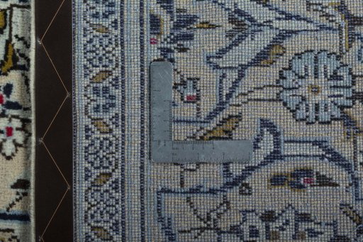 Backside of handmade 2000s Kashan rug showing knot structure and weave density